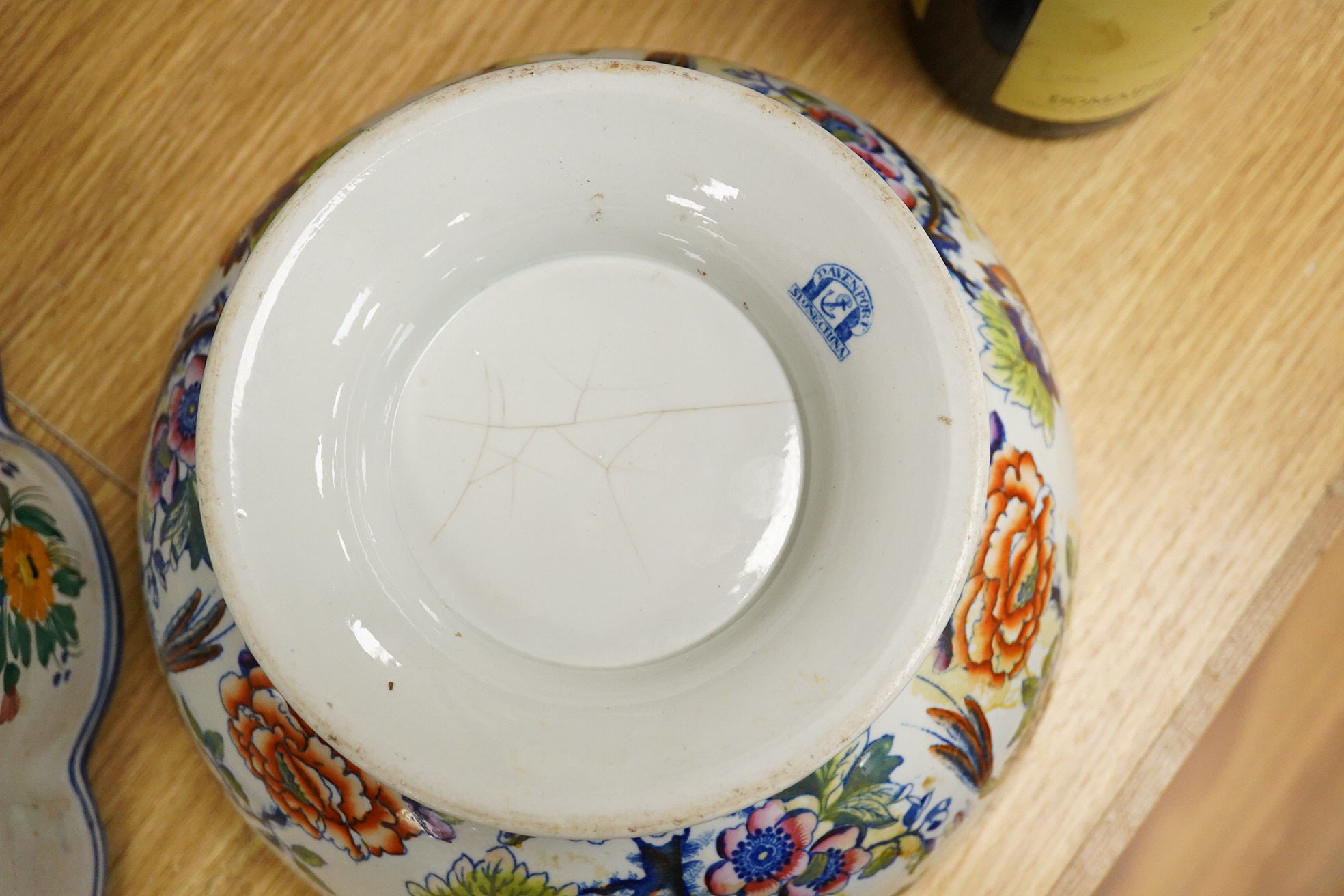 An Italian faience punch bowl painted with flowers and masks and an ironstone pedestal bowl, largest 31cm in diameter